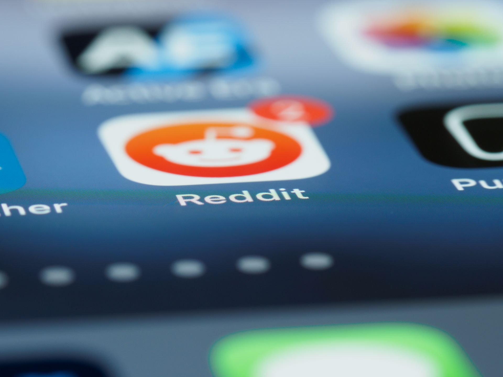 Close-up of the Reddit app icon with a notification badge on a smartphone screen